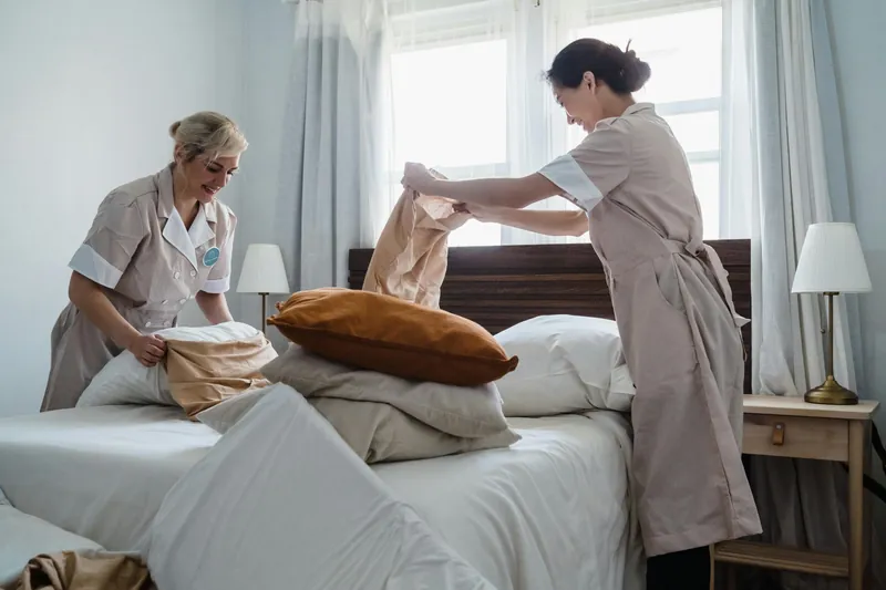 Femme de chambre préparant une chambre d'hôtel